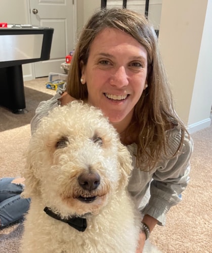 Coach Kelly smiling with her dog
